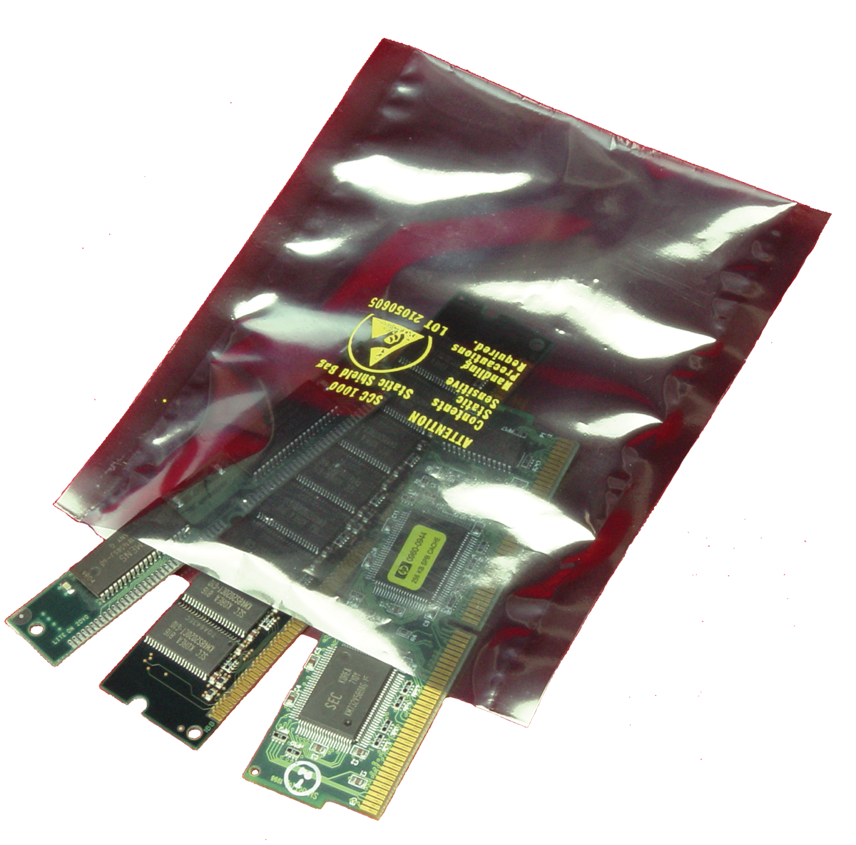 three microchip boards inside metallic static shielding bag on white background