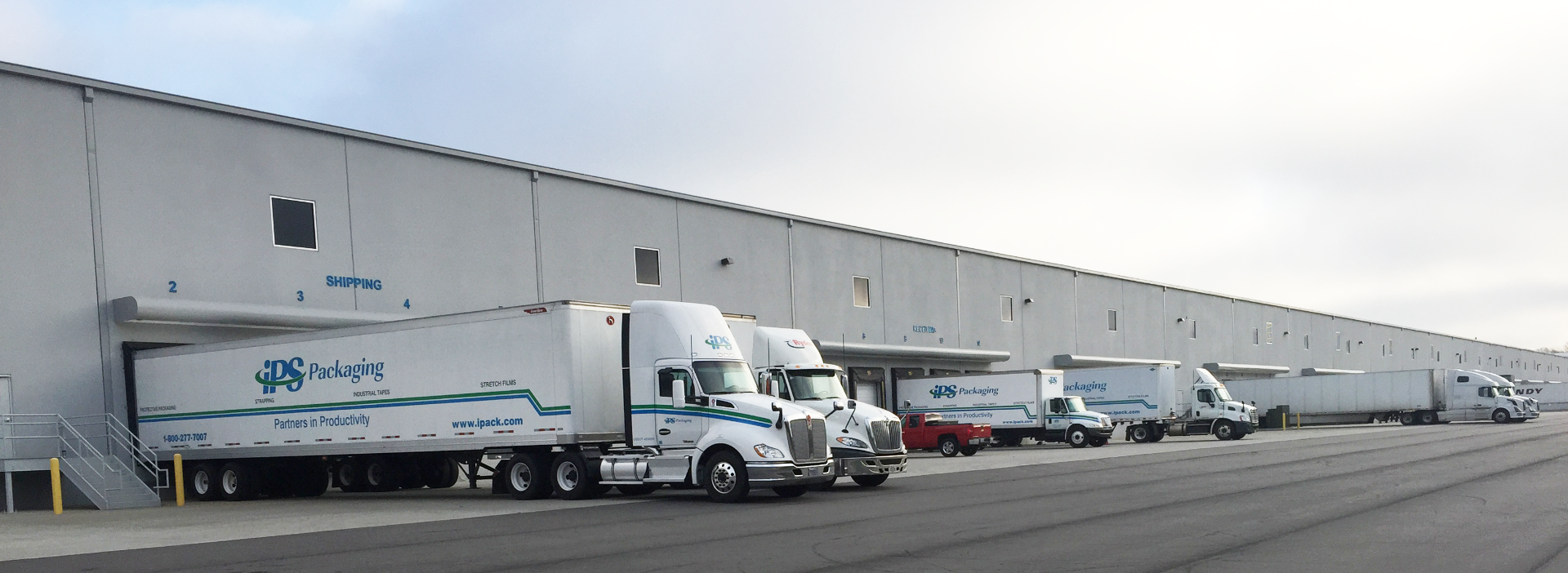 ips packaging & automation semi trucks backed into loading dock at warehouse