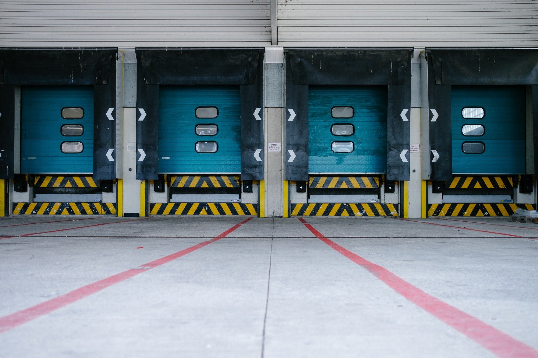 four blue loading doors in docking bay