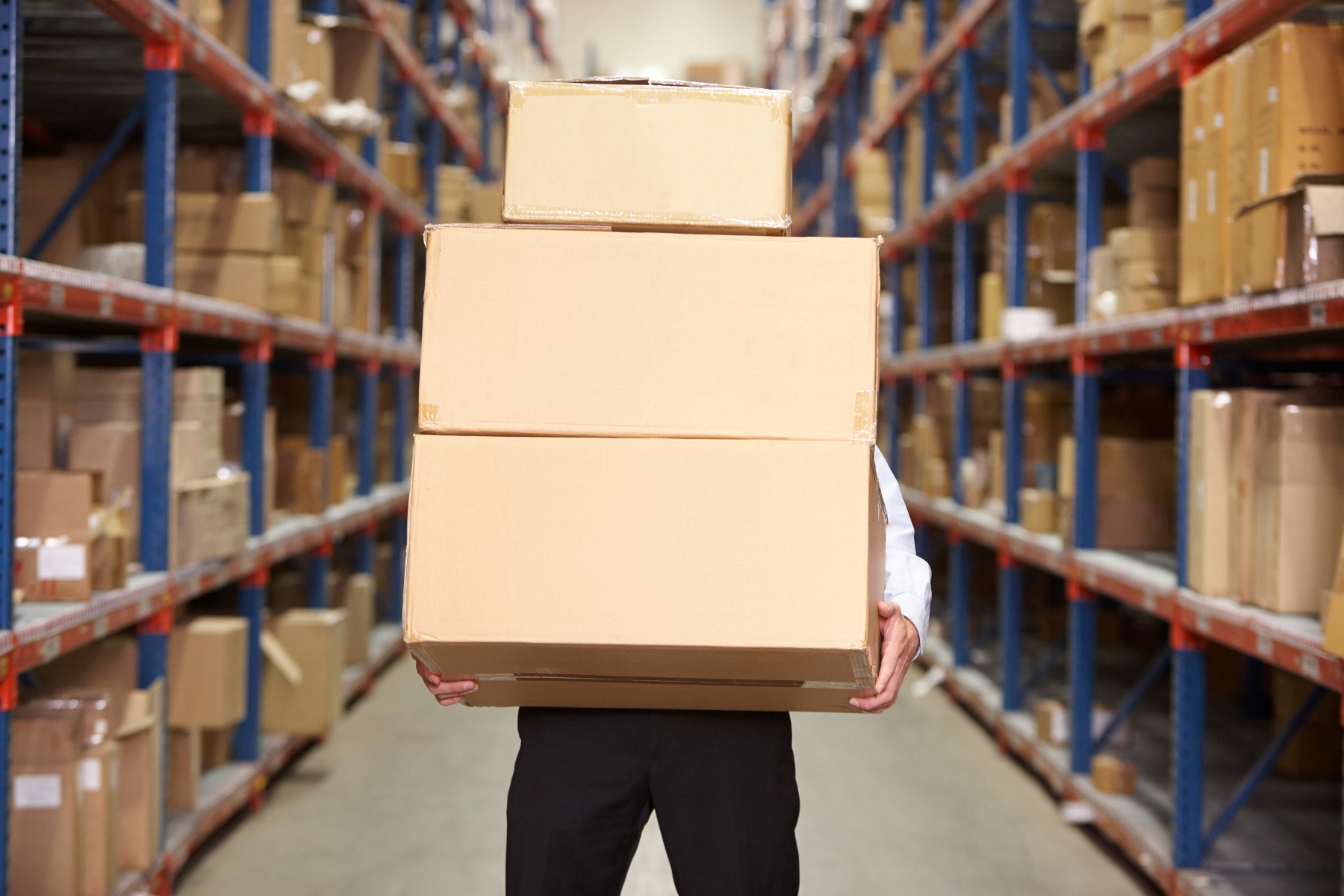 man-carrying-boxes-in-warehouse-PLF862H